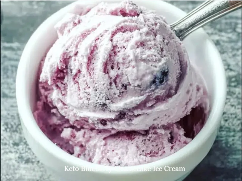 Keto Blueberry Cheesecake Ice Cream 1 Delicious Keto Blueberry Cheesecake Ice Cream in a bowl, topped with fresh blueberries